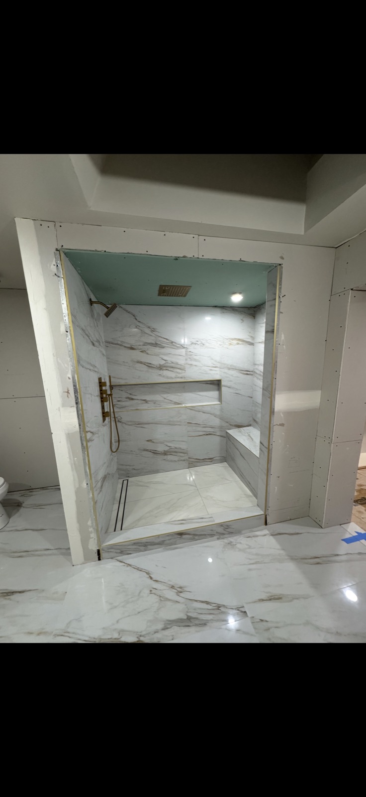 Luxury master bathroom remodel with marble floors, freestanding tub and walk-in shower by 5 Star Pros DMV