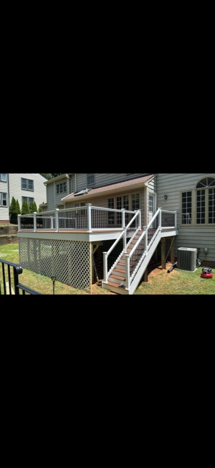 After: completed composite deck with white railings and black balusters by 5 Star Pros, DMV
