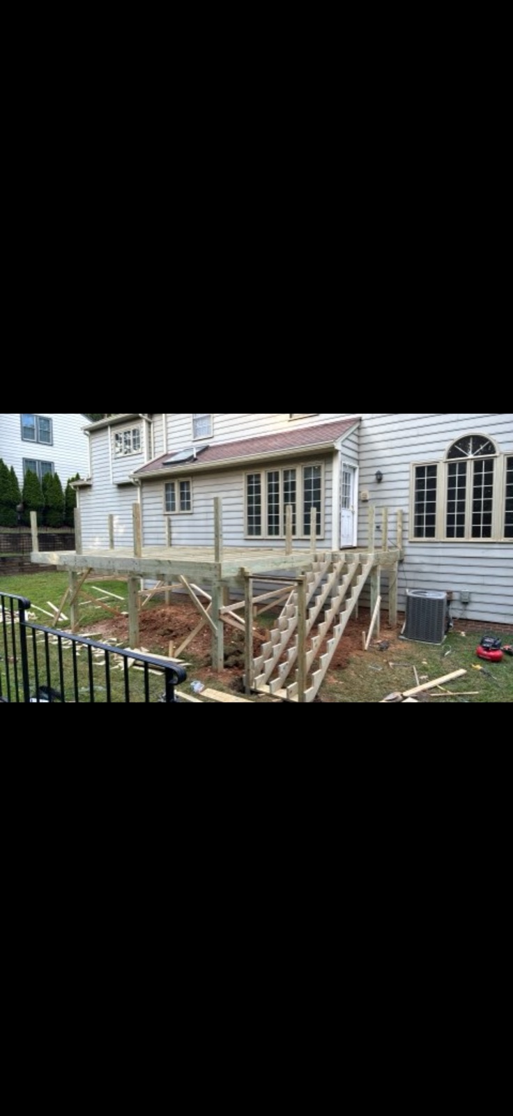 Before: raw wood deck frame under construction, no decking installed, DMV area