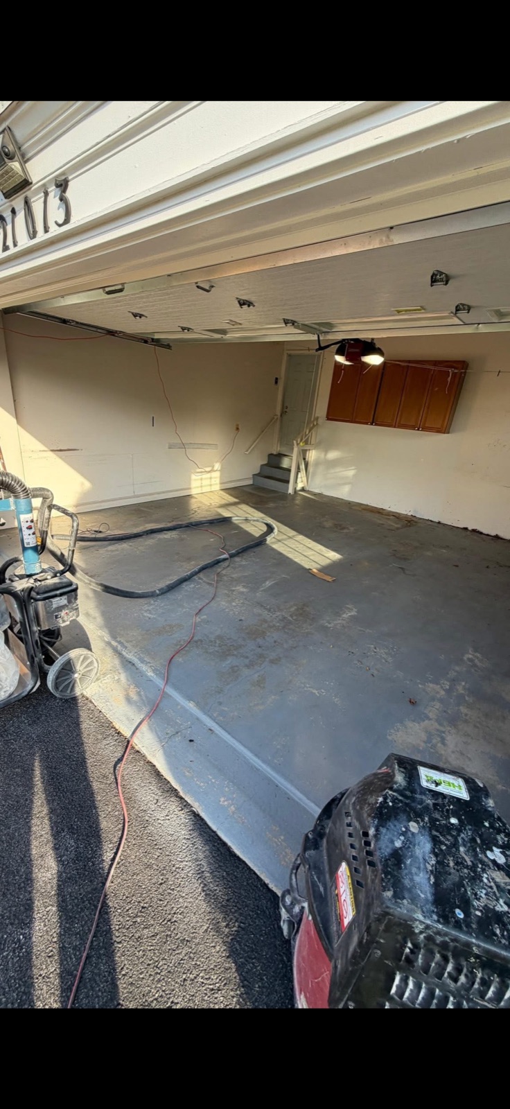 Before: bare concrete garage floor being prepped for epoxy coating by 5 Star Pros, DMV