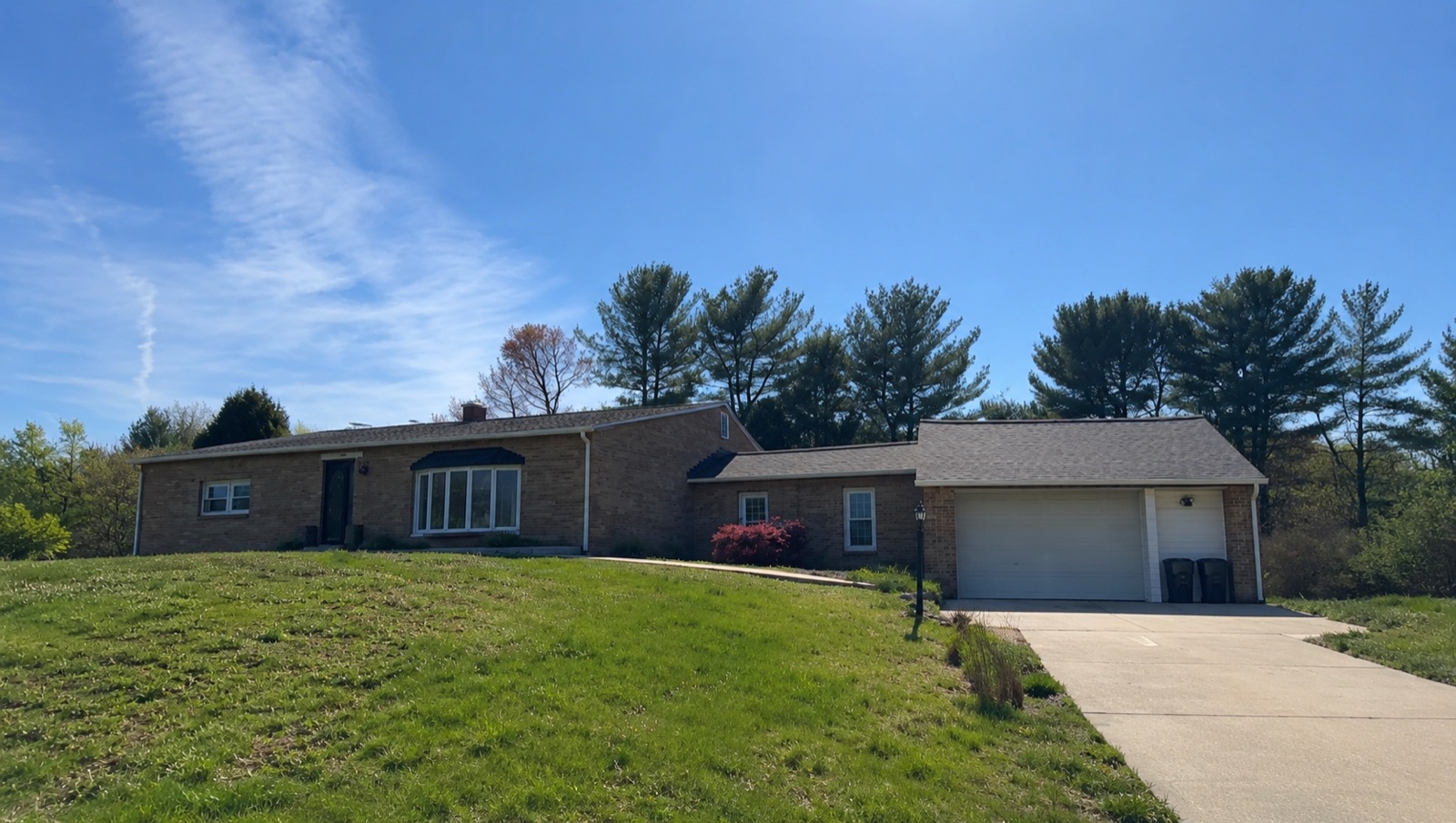 Before: brick house with faded unpainted exterior in the DMV area