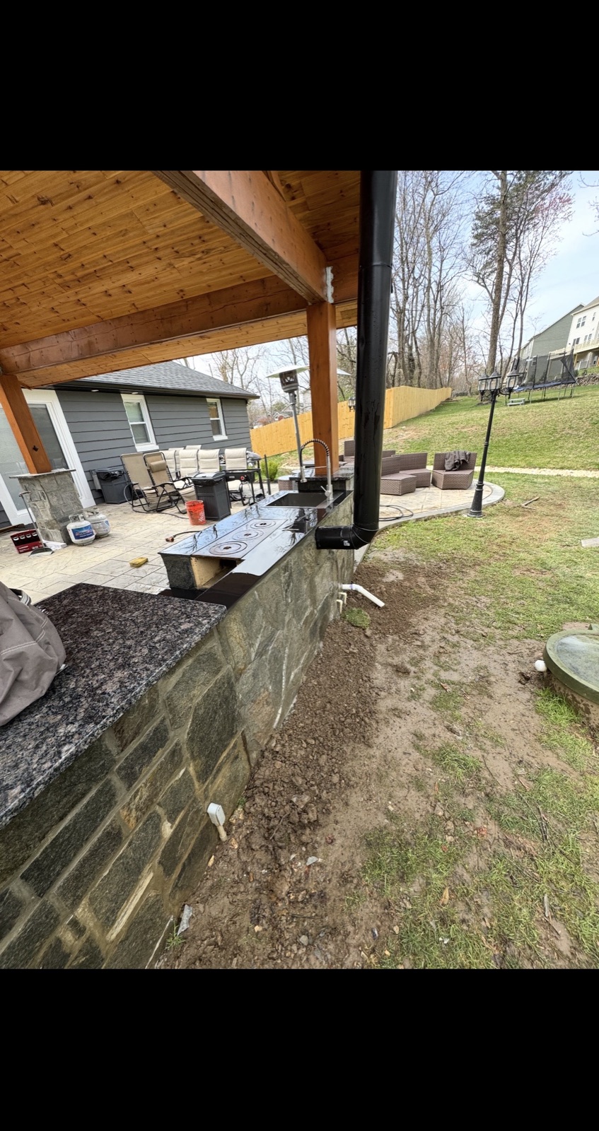 Outdoor kitchen granite countertop installation in progress on stone base, 5 Star Pros DMV