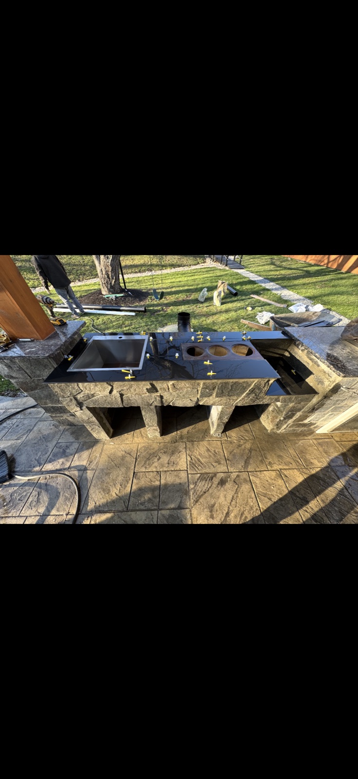 Black granite countertop installation on outdoor kitchen stone base by 5 Star Pros DMV