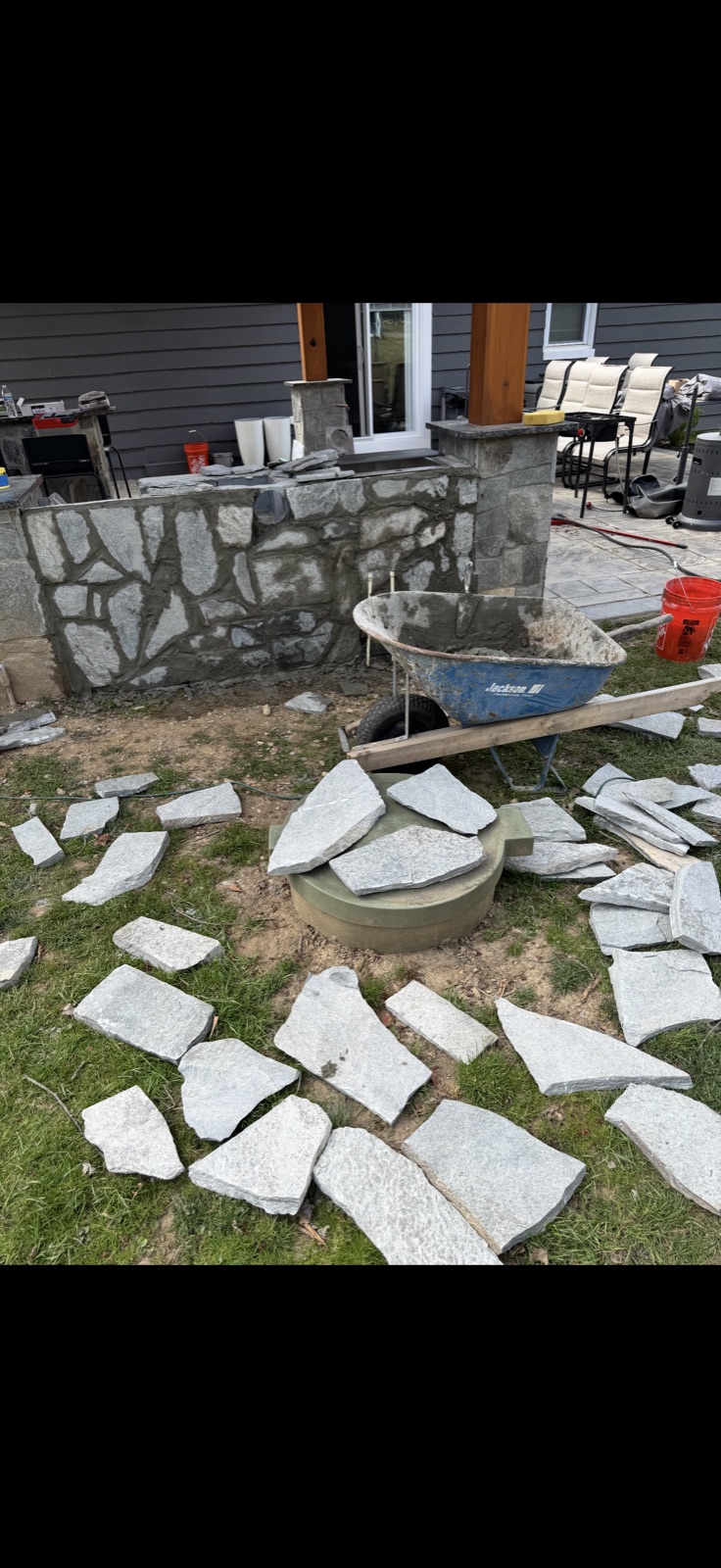 Outdoor kitchen stone masonry base and column construction in progress by 5 Star Pros DMV