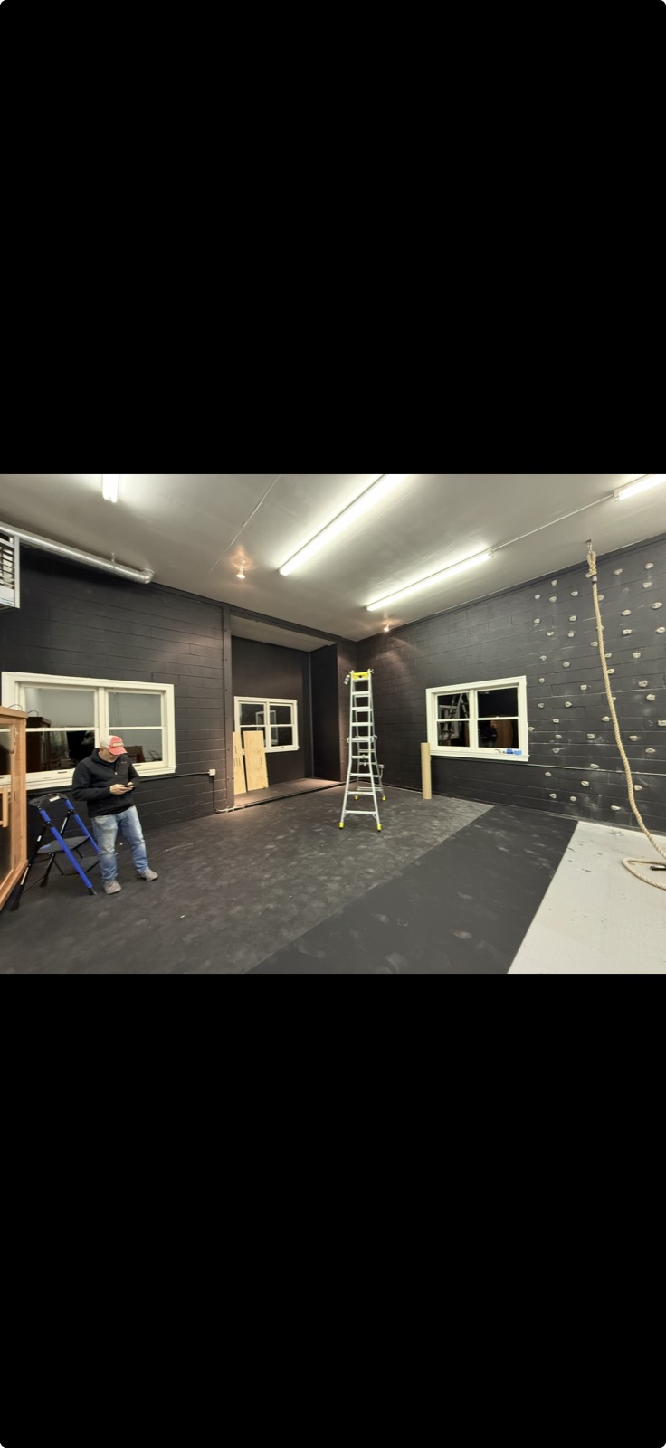 Commercial gym painted dark navy with climbing wall, 5 Star Pros painting, DMV area